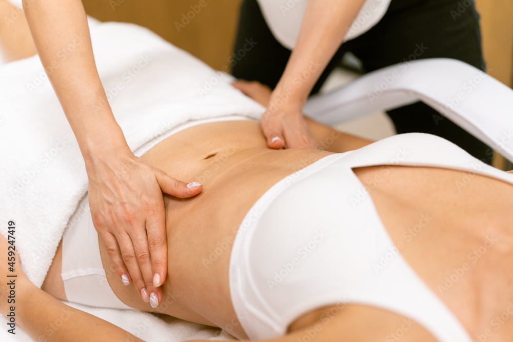 Middle-aged woman having a belly massage in a beauty salon. Middle-aged woman having a belly massage in a beauty salon.