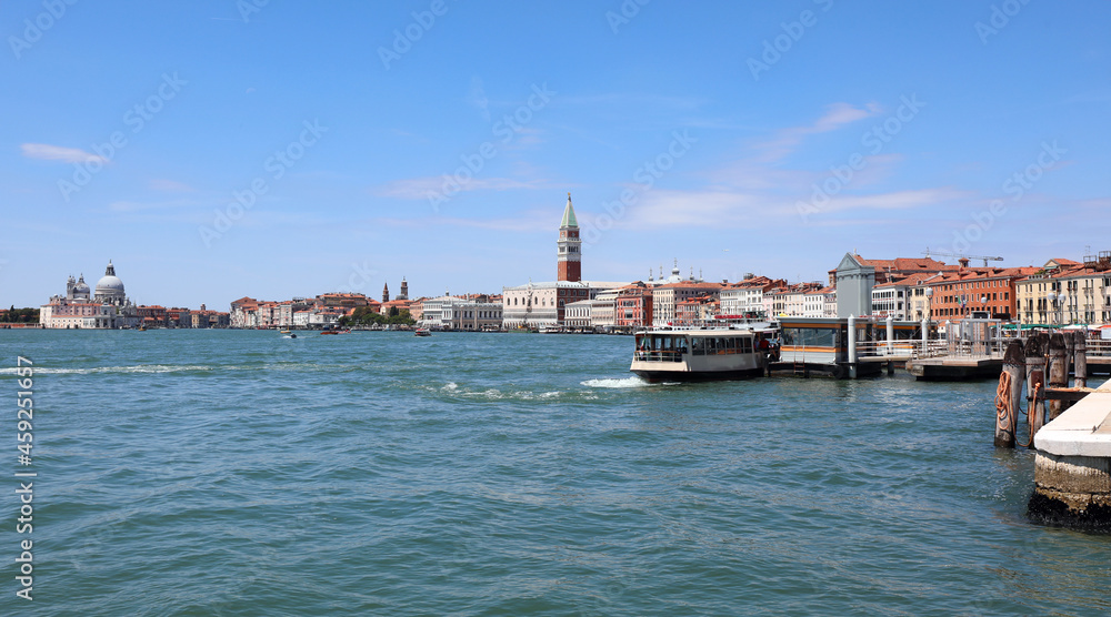 vaporetti of the island of VENICE in Italy with the bell tower of san marco and the ducal palace and very few boats during the lockdown