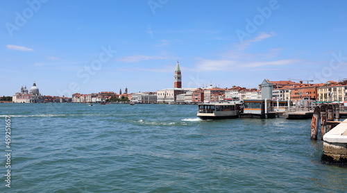 vaporetti of the island of VENICE in Italy with the bell tower of san marco and the ducal palace and very few boats during the lockdown