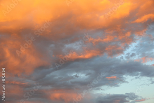 romantic sunset with big orange clouds during a summer evening