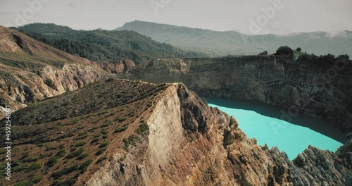 Blue crater lake on volcanic mountain. Aerial wild nature landscape. Azure turquoise water reservoir in natural volcano rock carter in mount highland. Beautiful nature background. Travel destinations photo