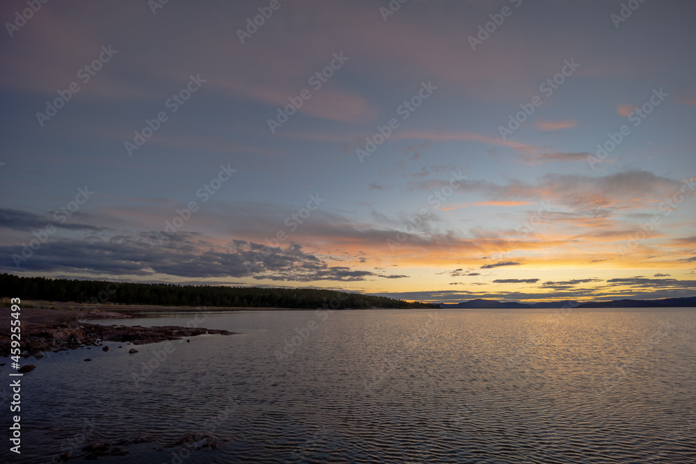 The view on the beech of the Bottenhavet inlet in Sweden. Made with setting sun towards the main land of Sweden.