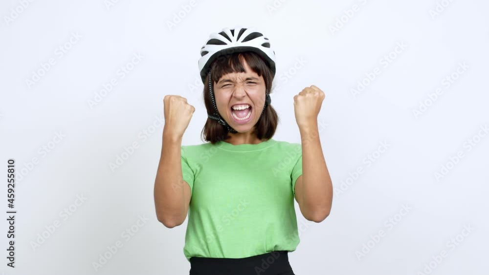 Young woman with bike helmet over isolated background celebrating a victory and surprised to be successful over isolated background Young woman with bike helmet over isolated background celebrating a victory and surprised to be successful over isolated background