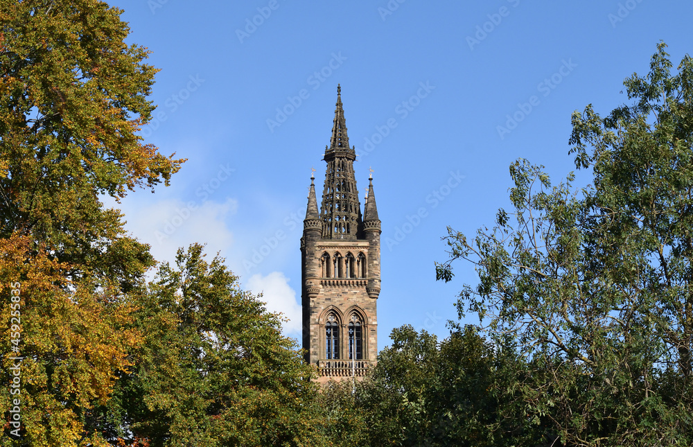 Old Gothic Stone Tower & Spire seen against Blue Sky 