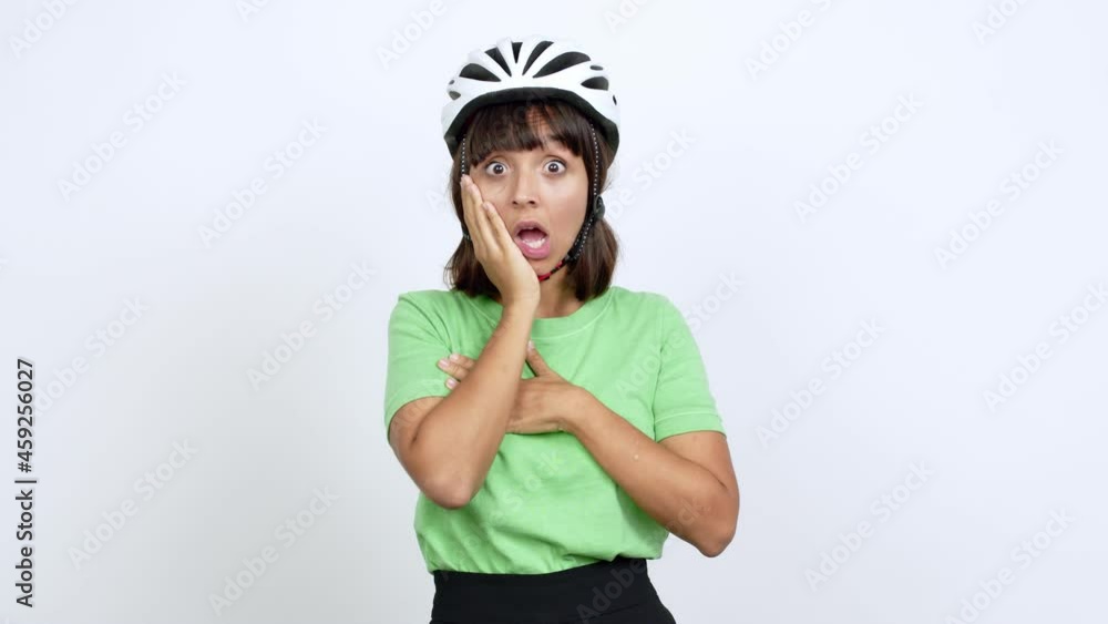 Young woman with bike helmet over isolated background gaping because have just surprised with a gift over isolated background Young woman with bike helmet over isolated background gaping because have just surprised with a gift over isolated background