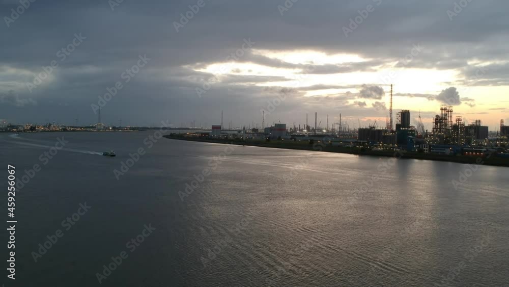 Industrial buildings of Antwerp harbor with evening lights, drone aerial view Industrial buildings of Antwerp harbor with evening lights, drone aerial view