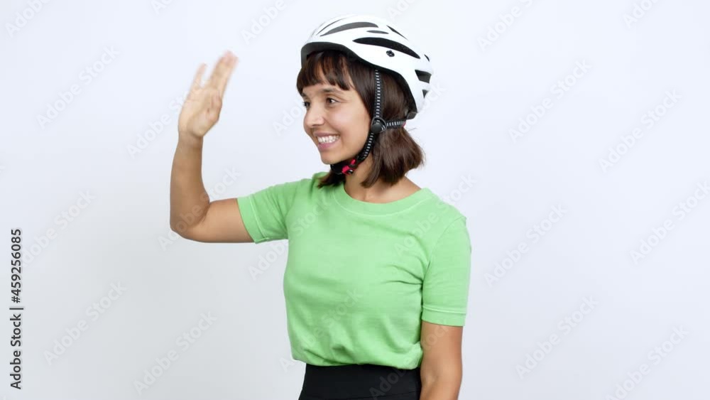 Young woman with bike helmet over isolated background shouting to the lateral and announcing something over isolated background Young woman with bike helmet over isolated background shouting to the lateral and announcing something over isolated background