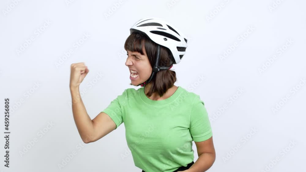Young woman with bike helmet over isolated background celebrating a victory over isolated background Young woman with bike helmet over isolated background celebrating a victory over isolated background