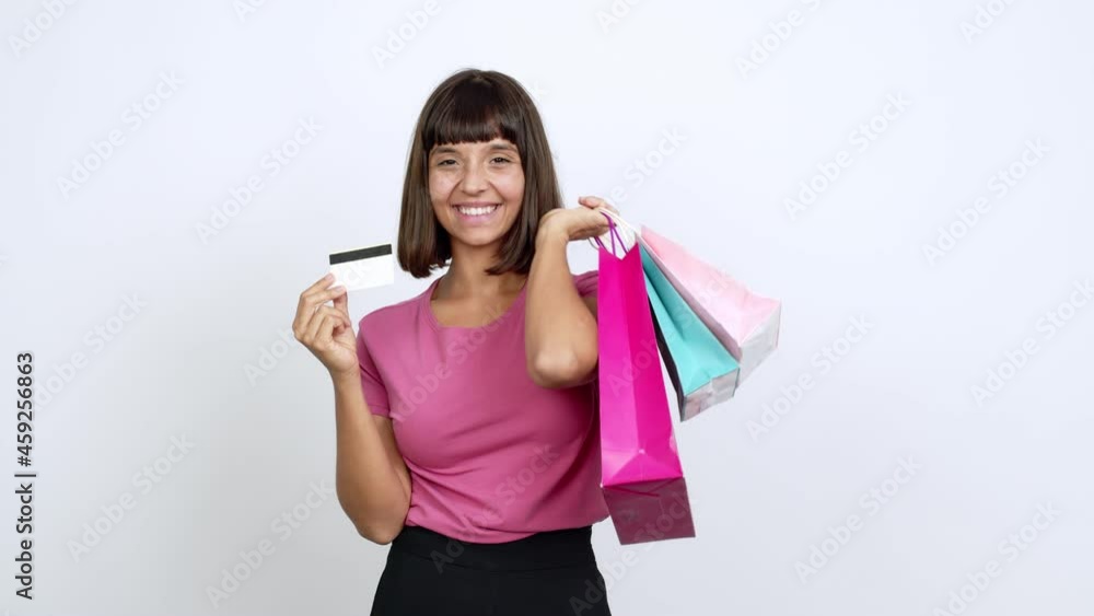 Young woman holding shopping bags isolated on background Young woman holding shopping bags isolated on background