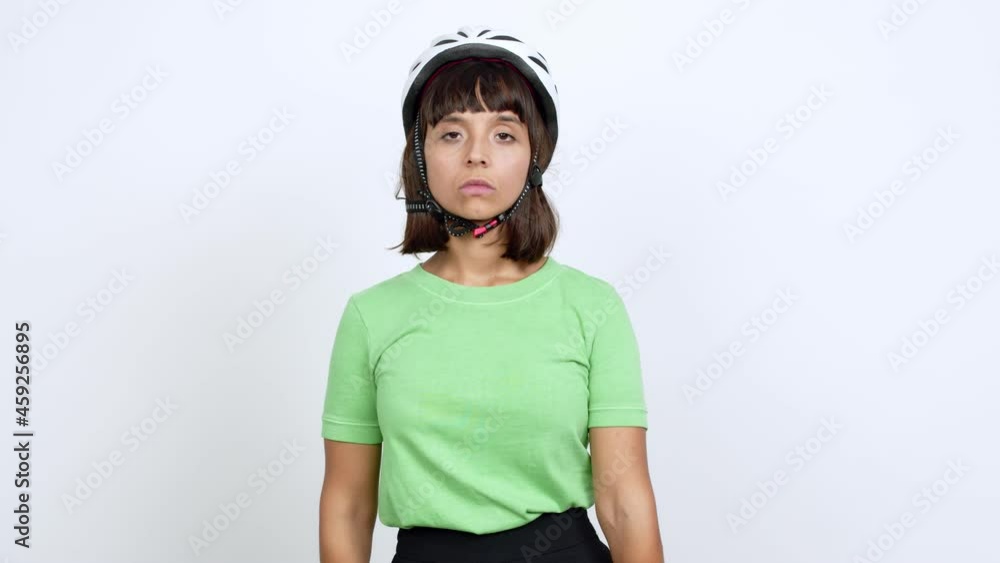 Young woman with bike helmet over isolated background doing stop sign over isolated background Young woman with bike helmet over isolated background doing stop sign over isolated background