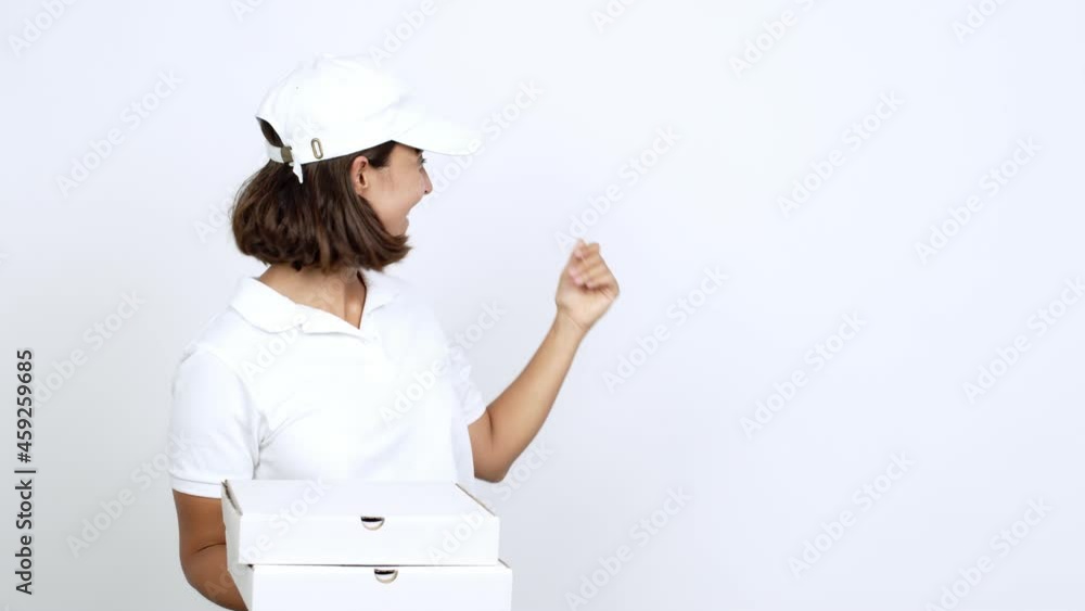 Young woman holding a pizza pointing back and presenting a product over isolated background Young woman holding a pizza pointing back and presenting a product over isolated background
