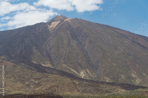Landscape of Teide volcano from a plain with blue sky and clouds overhead