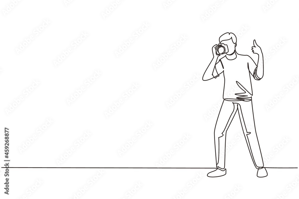 Single continuous line drawing photographer standing, thumbs up gesture, holding photo camera and photographing. Creative profession or occupation. One line draw graphic design vector illustration Single continuous line drawing photographer standing, thumbs up gesture, holding photo camera and photographing. Creative profession or occupation. One line draw graphic design vector illustration