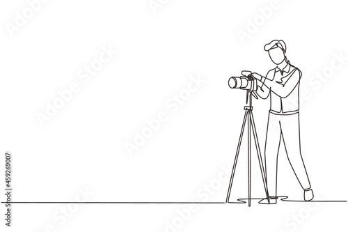 Single continuous line drawing photographer taking photos using professional equipment set, Man with camera making pictures. Studio photo equipment. One line draw graphic design vector illustration