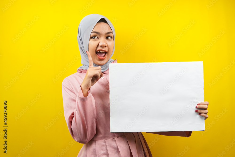 Pretty young muslim woman cheerful holding blank empty banner, placard, white board, blank sign board, white advertisement board, presenting something in copy space, promotion Pretty young muslim woman cheerful holding blank empty banner, placard, white board, blank sign board, white advertisement board, presenting something in copy space, promotion