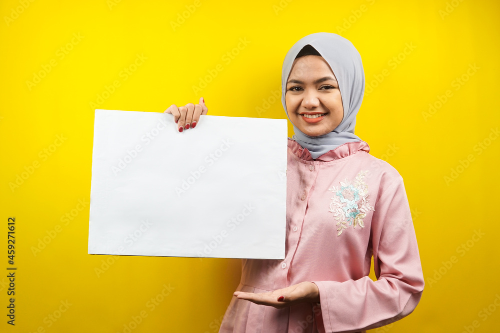 Pretty young muslim woman cheerful holding blank empty banner, placard, white board, blank sign board, white advertisement board, presenting something in copy space, promotion Pretty young muslim woman cheerful holding blank empty banner, placard, white board, blank sign board, white advertisement board, presenting something in copy space, promotion