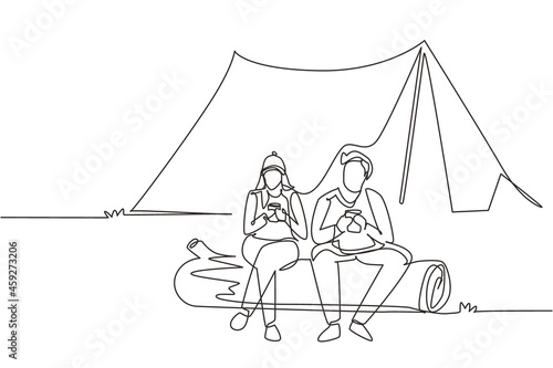 Single continuous line drawing couple sit on log near bonfire, active recreation, romantic date camping. Man woman drink hot coffee getting warm near campfire. One line draw design vector illustration