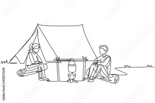 Continuous one line drawing couple man woman hikers sitting on log cooking meals in bowler boiling pot at campfire near camp tent camping nature mountains. Single line draw design vector illustration