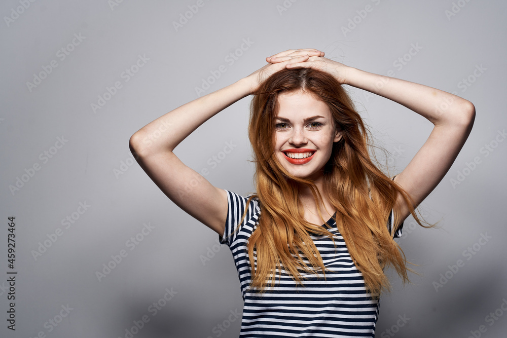 cheerful woman holding hair makeup posing fun fashion expression light background cheerful woman holding hair makeup posing fun fashion expression light background
