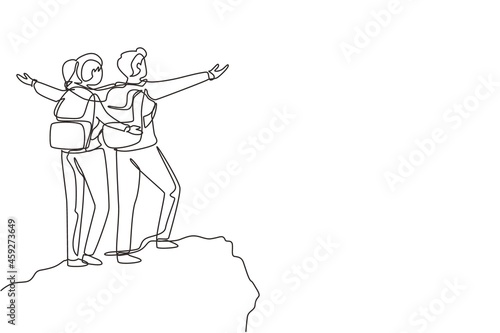 Single one line drawing couple climber man woman stands with arms outstretched on top of mountain. Winner motivational concept. Tourist with backpack. Continuous line draw design vector illustration