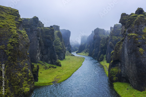 The famous and unique Fjadrargljufur valley in Iceland on a rainy day. Mossy cliffs and mountain river. Point of interest for tourists coming to visit Iceland