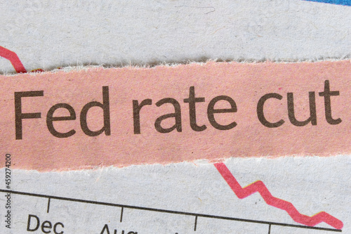 Принти на полотні A newspaper clipping on a news headline titled 'Fed rate cut' on top of a downward falling graph, macro closeup view