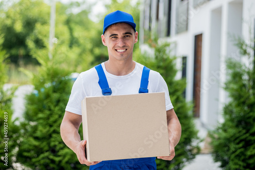 Young delivery man hold a cardboard box in his hands © romaset