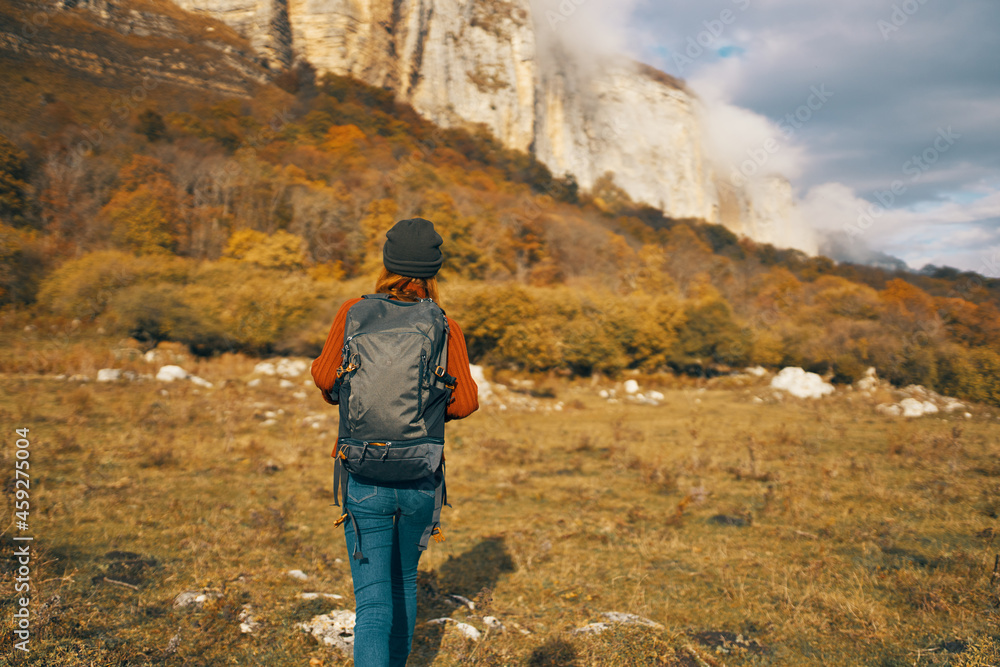 woman with backpack in jacket autumn travel mountains