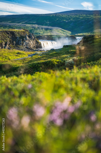 Godafoss waterfall in the Bardardalur district of North-Central Iceland, with defocused summer foliage in foreground photo