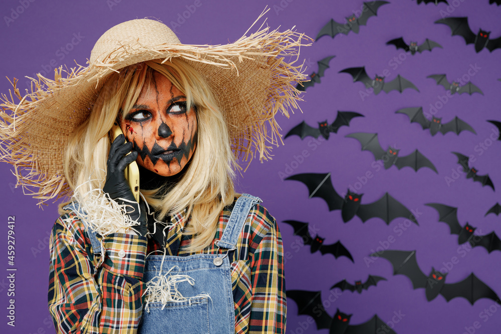 Young Creepy Woman With Halloween Makeup Mask In Scarecrow Costume Cover  Painted Face With Straw Hat Brim Isolated On Plain Dark Purple Background  Studio Portrait Celebration Holiday Party Concept Stock Photo 