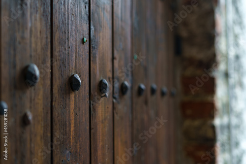 Medieval wooden door with decorative metal fittings.
