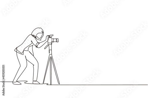 Single continuous line drawing super equipment female photographer, Woman holding, aiming cameras with standing tripod, carrying accessories for photographing. One line draw design vector illustration