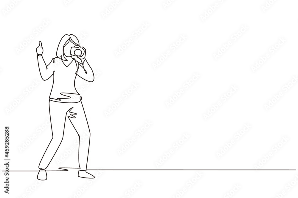 Single continuous line drawing cute woman photographer standing, thumbs up gesture, holding photo camera and photographing. Creative profession or occupation. One line draw design vector illustration Single continuous line drawing cute woman photographer standing, thumbs up gesture, holding photo camera and photographing. Creative profession or occupation. One line draw design vector illustration