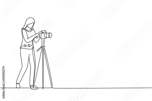 Continuous one line drawing female photographer taking photos using professional equipment set. Woman with camera making pictures. Studio photo equipment. Single line draw design vector illustration