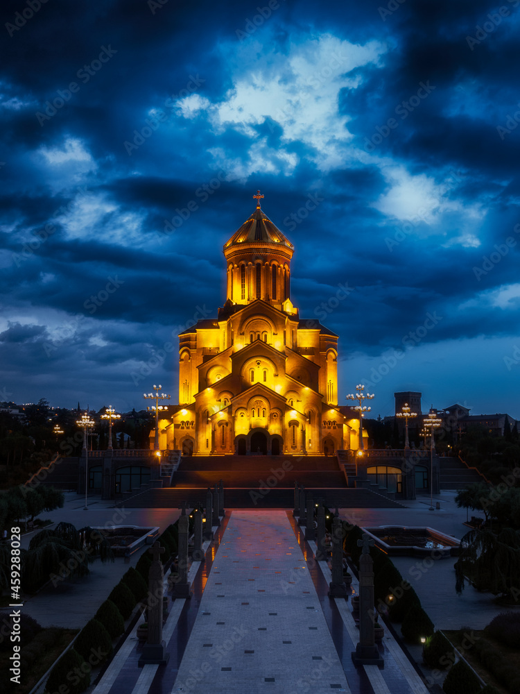 Cathedral on the background of blue night cloudy sky