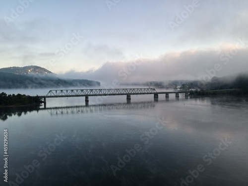 A bridge over water with a foggy sunrise. Bridge is on Lake Allatoona in Cartersville