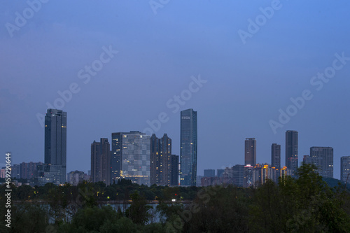 Urban skyscrapers under the rosy sky at nightfall;