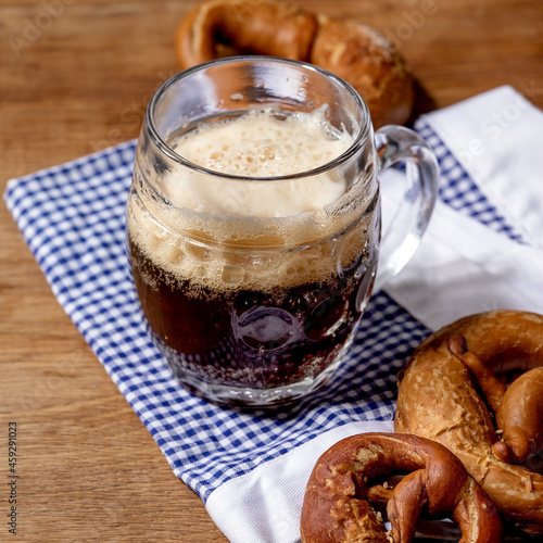 Glass of lager beer with traditional salted pretzels