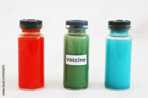 Three ampoules with a vaccine against the virus on a white background.