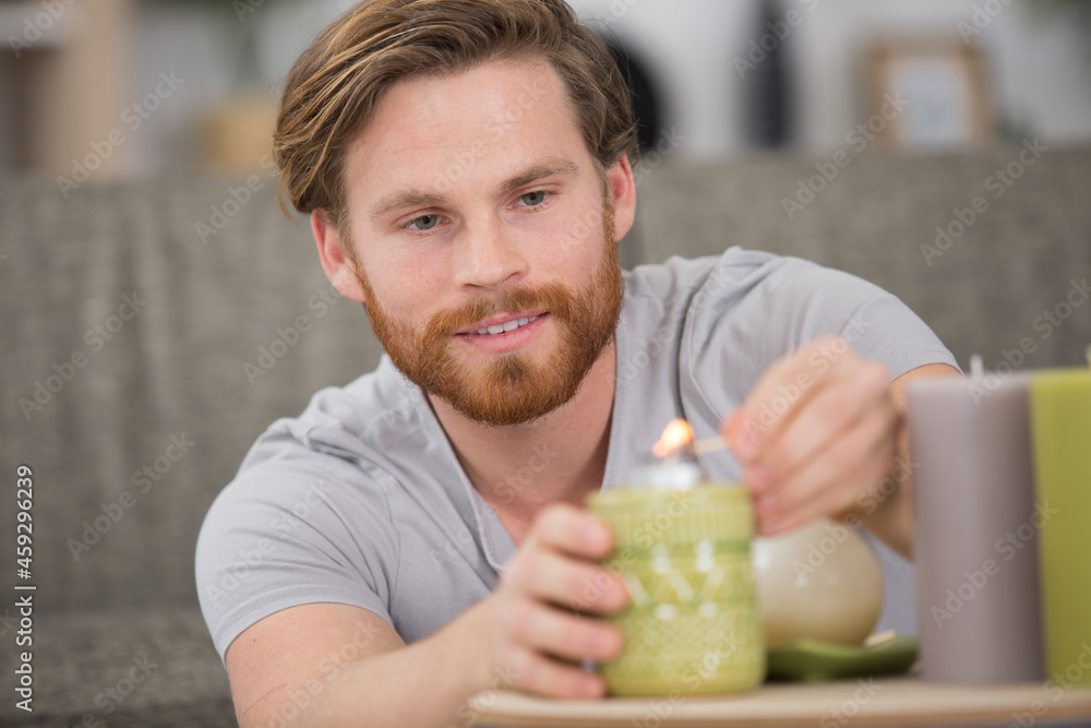 man lighting a red candle hand close up man lighting a red candle hand close up