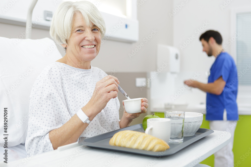 female retiree lying in bright apartment of clinic