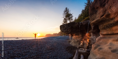 Adventurous White Caucasian Woman at Sandcut Beach on the West Coast of Pacific Ocean. Summer Sunny Sunset. Canadian Nature. Located near Victoria, Vancouver Island, BC, Canada.