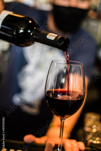Bartender pouring some red wine
