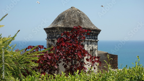 detail of a loophole of Gibralfaro Castle and color contrasts, Malaga, Andalusia, Spain