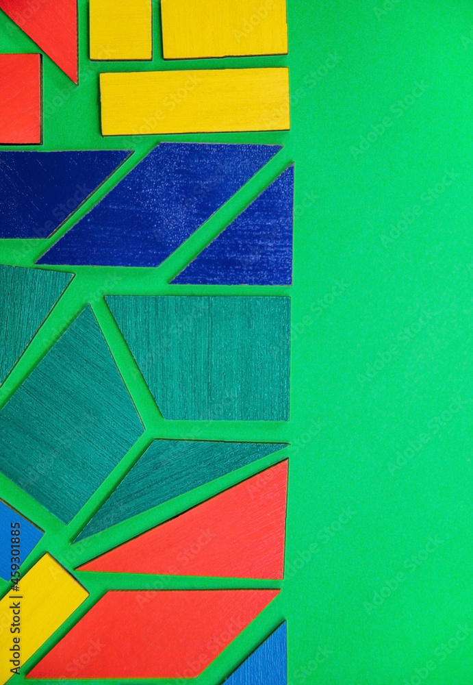 Abstract background.Geometric shapes in different colors on a green background. The concept of logical thinking. Abstract background.Geometric shapes in different colors on a green background. The concept of logical thinking.