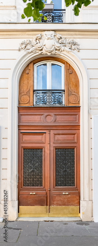 Paris, an ancient door, typical building in the 11e arrondissement 