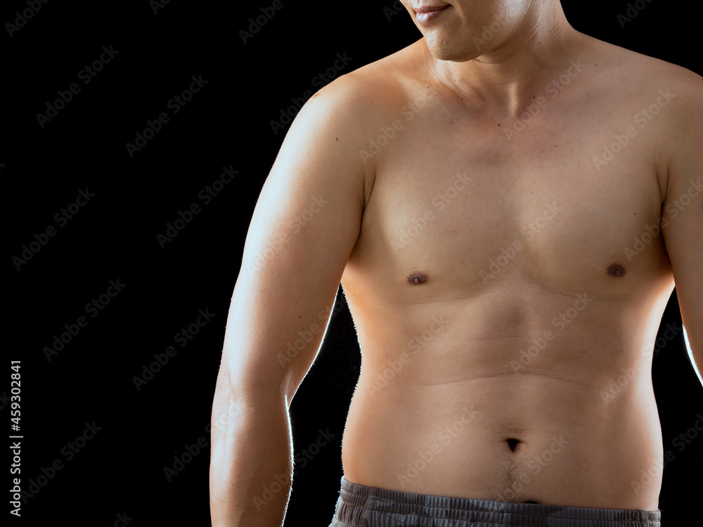 Young Asian man shirtless native pant posing relaxing body muscle on black background with copy space Young Asian man shirtless native pant posing relaxing body muscle on black background with copy space