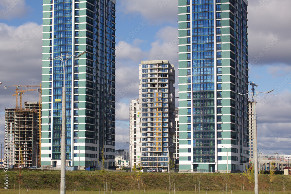 Construction of modern multi-storey buildings. Construction of a new city block. Buildings under construction and tower cranes. Construction of modern multi-storey buildings. Construction of a new city block. Buildings under construction and tower cranes.