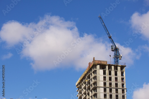 Construction of modern multi-storey buildings. Construction of a new city block. Buildings under construction and tower cranes.