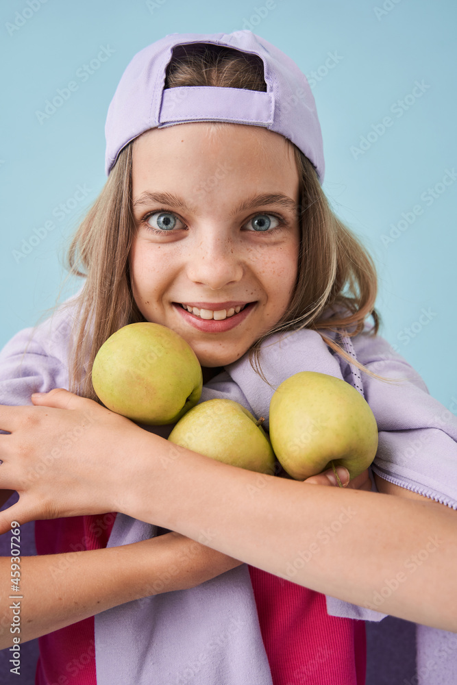 Smiling european little girl holding three apples Smiling european little girl holding three apples